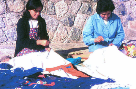 The Collective Embroidery Dos bordadoras trabajando en sus secciones del Bordado Colectivo en la terraza de Leonor en Isla Negra
